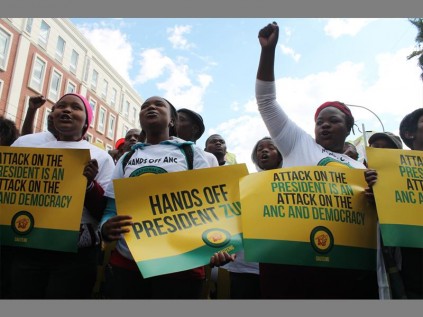 Marchers hold placards defending Jacob Zuma and the ANC.