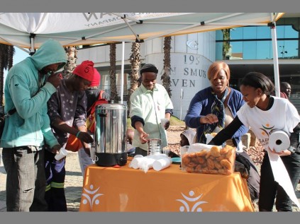 Employees of insurance company, SAFRICAN, give food to the homeless in Rosebank.