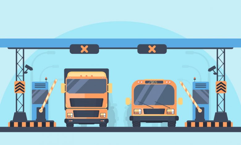 Toll higway. Toll gate construction. Arch for automatic charging on a toll road. Bus and lorry truck on roadway.