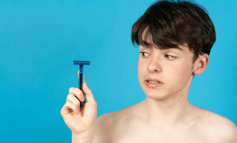 Teenager boy holding razor