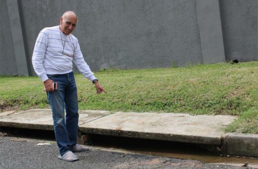 Sandy Goldbaum points at the blocked storm drain