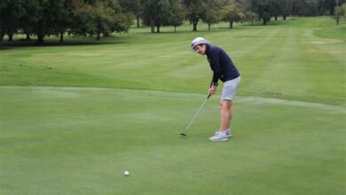 Liz Horn watches the golf bal