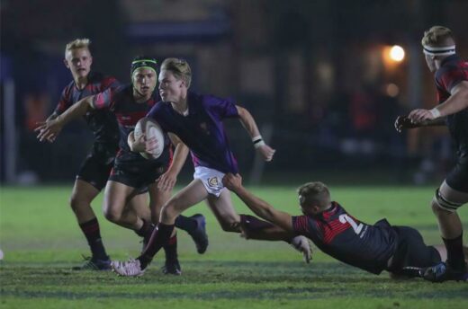 Joe MacRobert from St John's College runs with the ball.