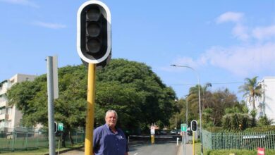 Michael van Rooyen stands next to a non-working traffic lights