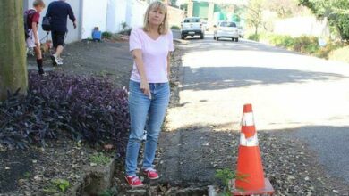 Cynthia Geffen points to the exposed stormwater drain along Ash Street in Upper Houghton. Photo: Asanda Matlhare