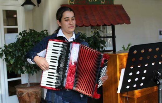 Isabella Martins smiles as she plays the accordion for Park Care residents. Photo: Asanda Matlhare