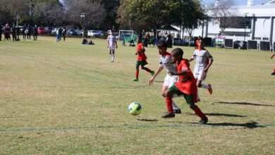 Roshnee U13 player Hamza Jamshaid and Old Eds player, Liyahlula Nana race for the soccer ball. Photo: Asanda Matlhare