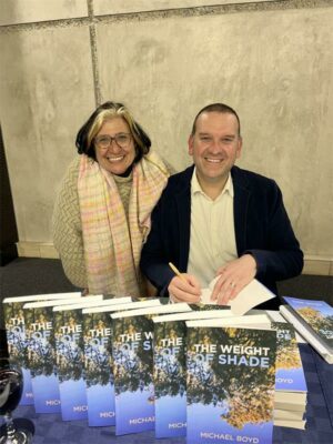 Michael Boyd signs the book for an audience.