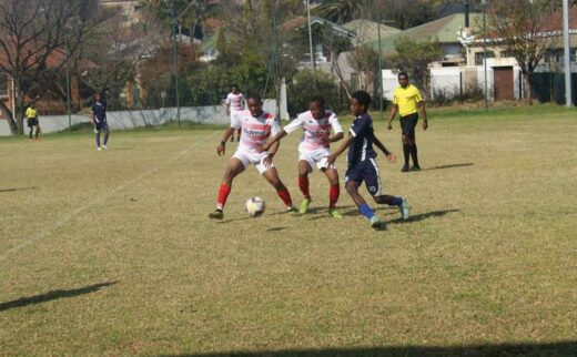 Norwood Young Stars players (in white and pink stripes) dominate Polokwane Rovers (in blue) player as they possess the ball. Photo: Naidine Sibanda