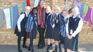 Computer teacher and marketing liaison at St Teresa's School, Lianda May (third from right) with Grade 4 learners after they hung scarves on Sturdee Avenue. Photo: Naidine Sibanda