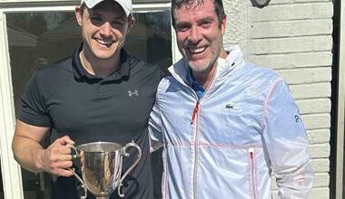 Pirates Tennis Club champion Stephen Mark celebrates his win in the singles finals with George Chauvet.