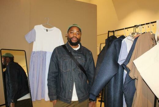 Designer, Neimil stands next to his clothing line. Photo: Asanda Matlhare