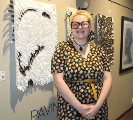 Exhibitor, Zoey Trapani stands next to her work. Photo: Asanda Matlhare