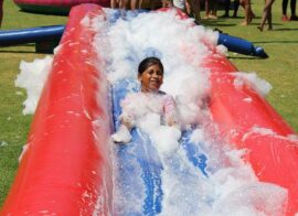 Alexus Moodley slides in the foam. Photo: Asanda Matlhare
