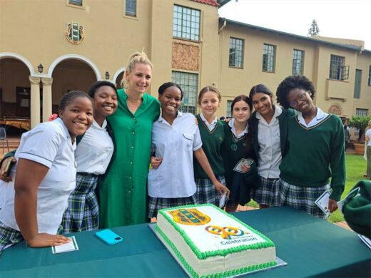 Learners and their teacher are happy to be a part of the celebration.