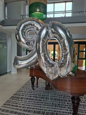 Balloons are put up at the school's reception to celebrate 90 years.