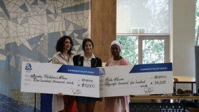 Nicky Katz from the Chevra Kadisha receives a cheque donation from Gina Dave with Connie Biyela from Kids Haven.