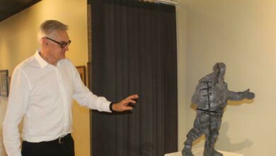 Senior art specialist Wilhelm Van Rensburg points to one of the art works. Photo: Naidine Sibanda