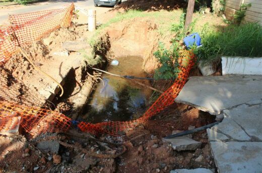 A dug-up and exposed hole in a driveway collects water in Lyndhurst. Photo: Asanda Matlhare