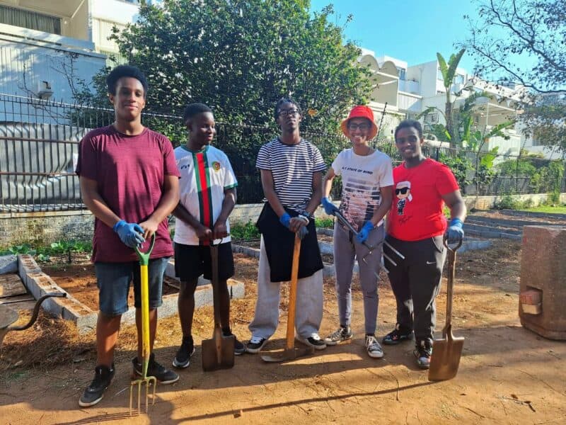 Learners from Parktown Boys’ High and Holy Family College dug deep in Killarney Park, turning soil and spirits as they helped expand the community vegetable garden.