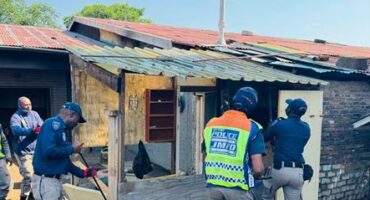 Law enforcement officials (JMPD) inspect and dismantle a small, makeshift dwelling during the operation to remove illegal structures and reclaim the municipal land on October 8, 2025 at the old Parkhurst Bowling Club. Photo: Supplied