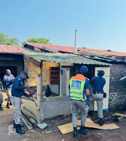 Law enforcement officials (JMPD) inspect and dismantle a small, makeshift dwelling during the operation to remove illegal structures and reclaim the municipal land on October 8, 2025 at the old Parkhurst Bowling Club. Photo: Supplied