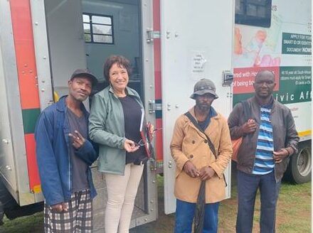 Cross the Divide volunteer, with displaced individuals by the Home Affairs mobile unit in September 2025. Photo: Supplied