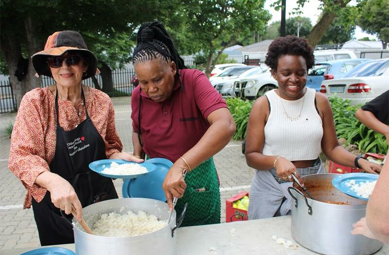 Local NPO, Cross the Divide, transforms a church parking lot into a festive outdoor dining space for 150 people in need.
