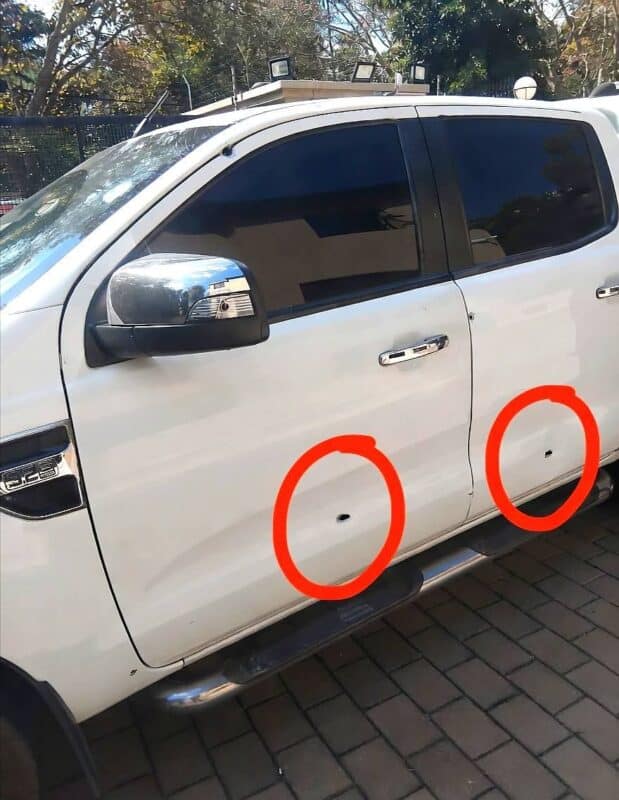 Gunmen ambush vehicle at law firm entrance in what police believe may be a targeted attack.