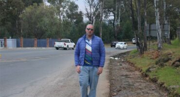 Ward 72 Councillor Daniel Schay stands next to the eroded part of Modderfontein Road on June 23, 2026. Photo: Asanda Matlhare