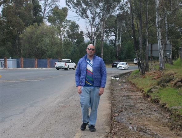 Ward 72 Councillor Daniel Schay stands next to the eroded part of Modderfontein Road on June 23, 2026. Photo: Asanda Matlhare