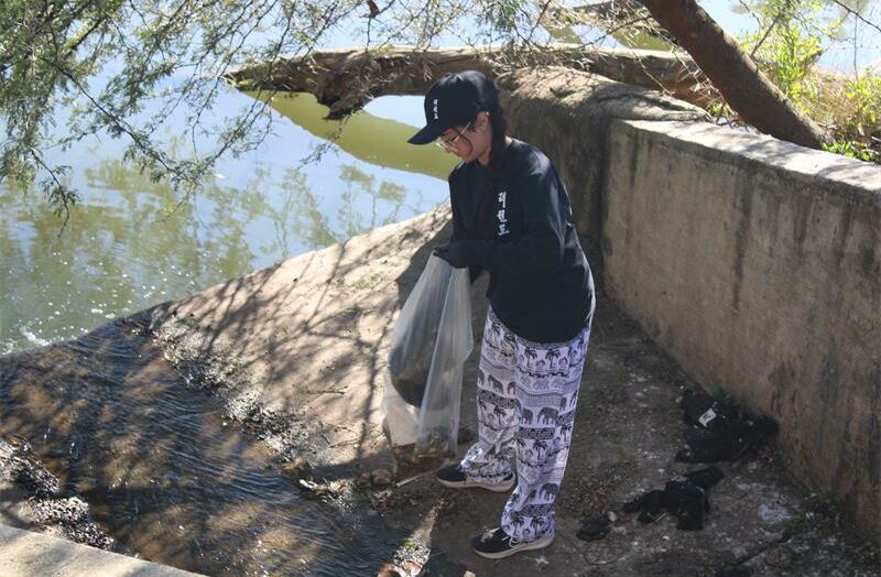 Lana Bhaga picks up litter as part of her 67 minutes at Zoo Lake on July 18, 2026. Photo: Asanda Matlhare