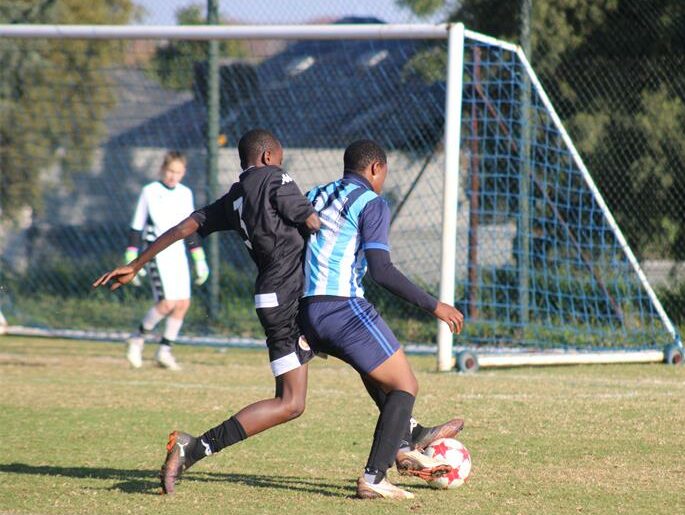 U13 Highlands Park player, Lucky Tshuma marks his Liso Africa opponent. Photo: Asanda Matlhare