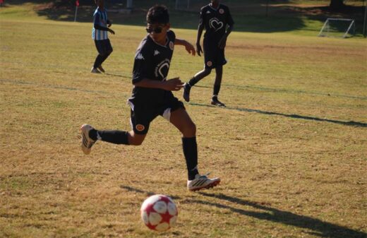 U13 Highlands Park player, Shay Seeripat scans the field before passing it on June 28, 2026. Photo: Asanda Matlhare