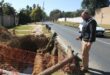 Ward 72 councillor David Schay observes an unattended excavation filled with water on July 2, 2026. Photo: Asanda Matlhare