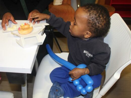 A patient, Kabelo Mabophe, decorates his donut for Reach for a Dream’s birthday on July 7, 2026. Photo: Asanda Matlhare