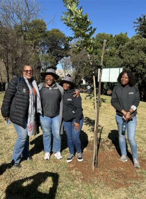 Rose Abdullah, Bongiwe Ndondo, Lettie Phale, and Judith Mhonyera stand proudly next to a tree they've planted on July 17, 2026. Photo: Asanda Matlhare