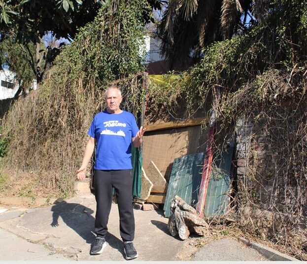 Ward 117 councillor Tim Truluck stands in front of the makeshift gate at the depilated property in Parktown. Photo: Asanda Matlhare