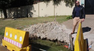 Ward 72 councillor David Schay observes a flooded excavation on July 2, 2026. Photo: Asanda Matlhare