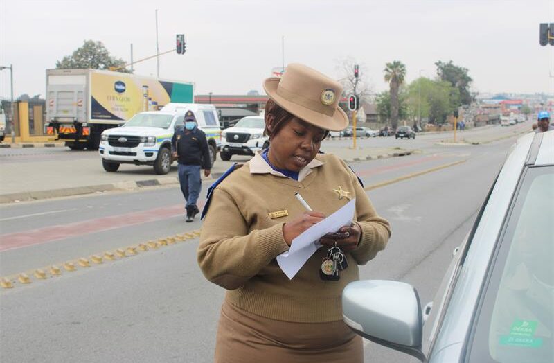 Provincial Inspector Makgabo Masoga speaks to a motorist while recording information during Bramley SAPS’ Operation Basadi on Pretoria Main Road. Photo: Thato Modopi