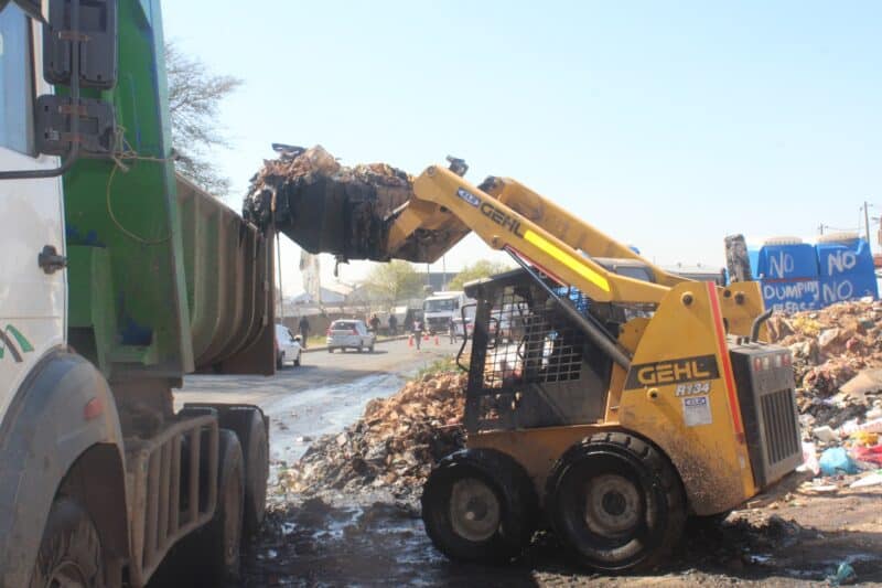 A skid-steer loader cleans-up waste at Organic Market informal settlement on August 20, 2026. Photo: Asanda Matlhare