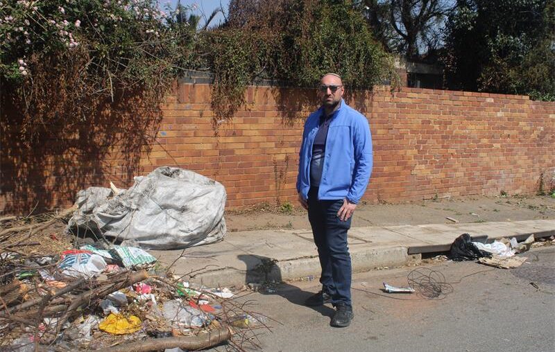 Ward 72 councillor, Daniel Schay stands next to the neglected property in Sydenham on August 28, 2026 Photo: Asanda Matlhare
