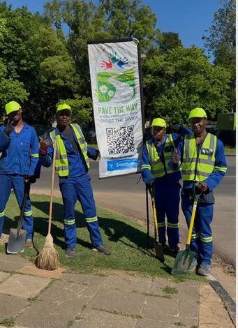 Team members of the Pave the Way community initiative work to clean and restore pavements along major routes like Jan Smuts Avenue, providing employment and purpose for displaced individuals. Photo: Naziya Davids-Easthorpe