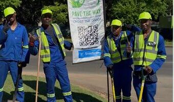 Team members of the Pave the Way community initiative work to clean and restore pavements along major routes like Jan Smuts Avenue, providing employment and purpose for displaced individuals. Photo: Naziya Davids-Easthorpe