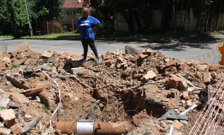 Ward 74 councillor Belinda Echeozonjoku stands on the dangerous excavation on the corner of 28 Junction Road in Bramley on October 13, 2026. Photo: Asanda Matlhare