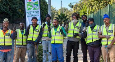 Team members of the Pave the Way community initiative work to clean and restore pavements along major routes like Jan Smuts Avenue, providing employment and purpose for displaced individuals. Photo: Naziya Davids-Easthorpe