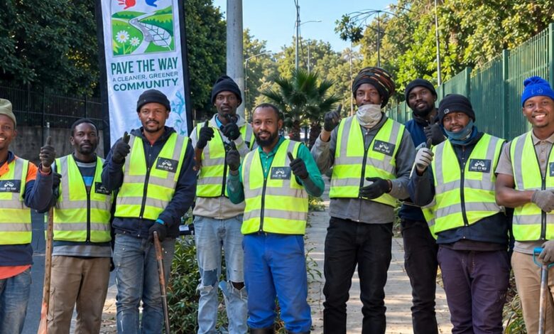 Team members of the Pave the Way community initiative work to clean and restore pavements along major routes like Jan Smuts Avenue, providing employment and purpose for displaced individuals. Photo: Naziya Davids-Easthorpe