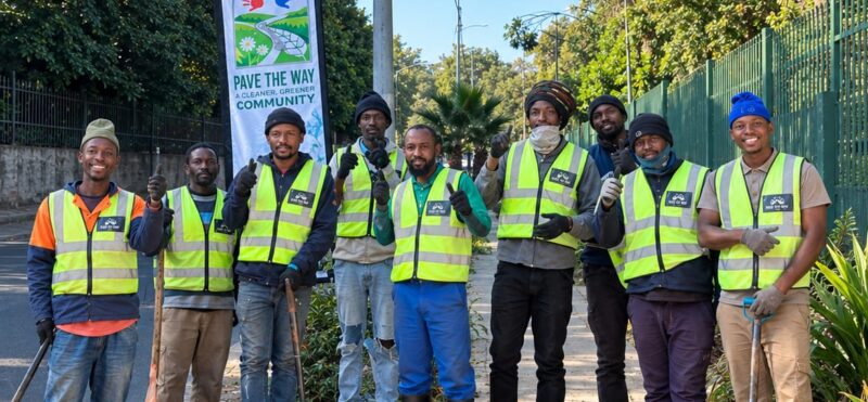 Team members of the Pave the Way community initiative work to clean and restore pavements along major routes like Jan Smuts Avenue, providing employment and purpose for displaced individuals. Photo: Naziya Davids-Easthorpe
