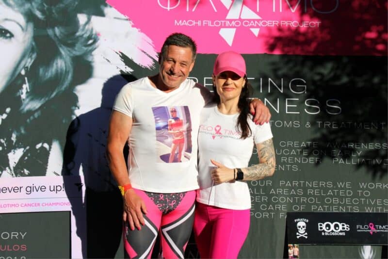 Brand ambassador Martin Scheepers and founder and director Evy Michalopoulos pose together in front of the Machi Filotimo Cancer Project backdrop at Pirates Club in Greenside on October 25, 2026. Photo: Naziya Davids-Easthorpe