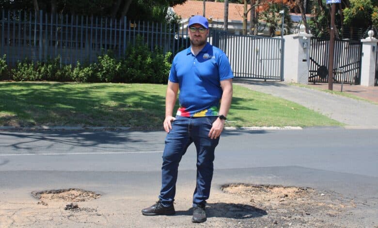 Ward 72 councillor Daniel Schay stands in between the new potholes that have emerged on Northfield Avenue. Photo taken on October 26, 2026 by Asanda Matlhare